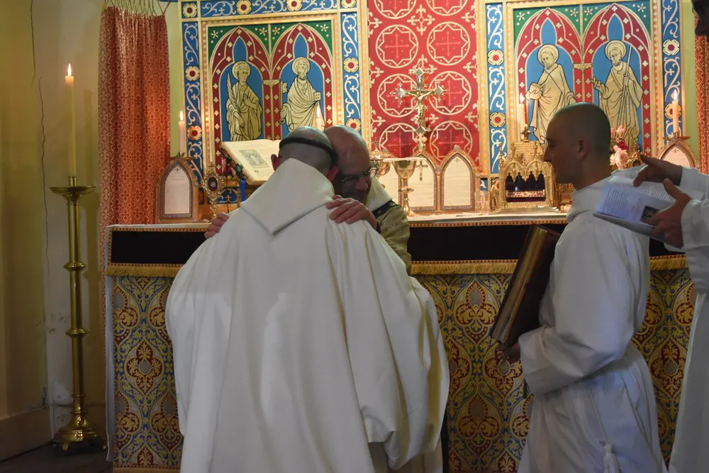 Fr Prior gives new monk the kiss of peace