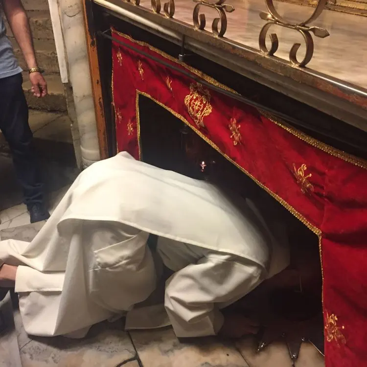 Venerating the spot of the Nativity of Our Lord in Bethlehem.